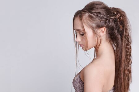 Bohemian style. Women Hairstyle with braid , romantic. Grey background Copytext