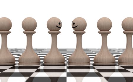 Two smiling chess figures among the another figures on white backgroundsの写真素材