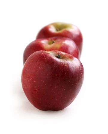 Row of red apples on a white background の写真素材