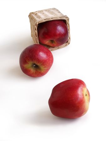 Red apples and basket on a white background の写真素材