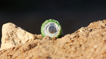Exhaust alkaline batteries improperly thrown away, not recycled and are poisoning the land.の写真素材
