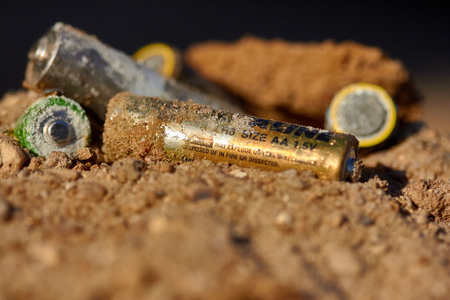 Exhaust alkaline batteries improperly thrown away, not recycled and are poisoning the land.の写真素材