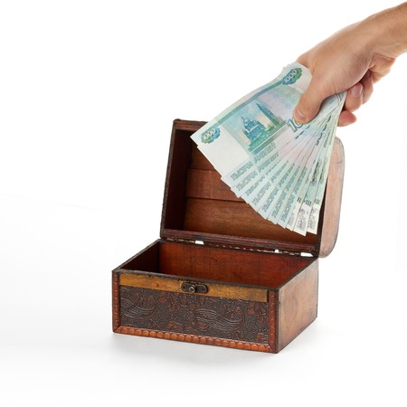Small wooden chest is partially filled with russian money roubles.の写真素材