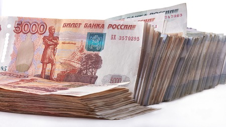 Bundle of rubles, a lot of money as background.