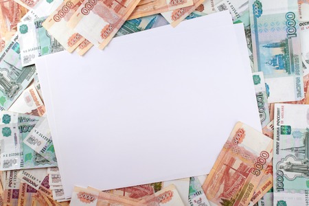 White paper sheet blank on the background a large number of rubles.の写真素材