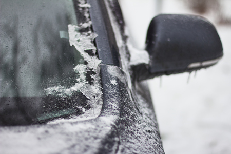 Car is completely covered with ice after freezing rain.の写真素材