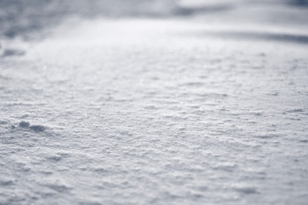 Flat surface ice crust. Texture of light and shadows on snow field.