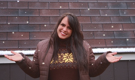Beautiful Cheerful Woman Playing in Snowの写真素材
