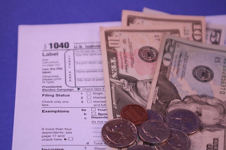 1040 Tax Form on Blue Background with Moneyの写真素材