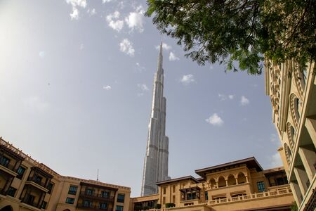 DUBAI, UAE - NOVEMBER 11, 2018: Burj Khalifa with Souq al Bahar apartment buildings in front