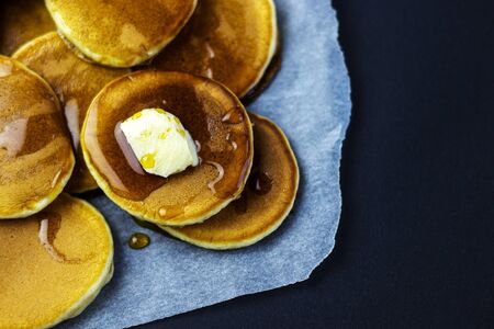 freshly prepared pancakes with maple syrup for breakfastの写真素材