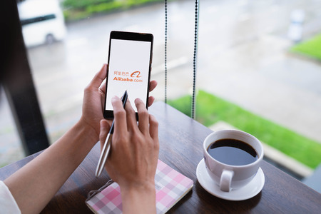 CHIANG MAI, THAILAND - August 18,2018: Woman hands holding HUAWEI with alibaba apps on screen.Alibabaâs the the world's biggest online commerce company. Itâs three main sites Taobao,Tmall and Alibaba.のeditorial素材