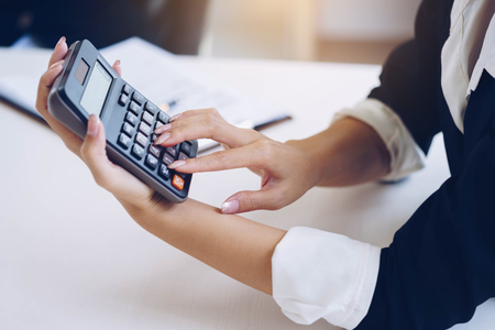 Businesswoman holding calculator for calculate number and discussing new plan project in meeting room. Meeting brainstorming and discussing project. Teamwork concept.の写真素材