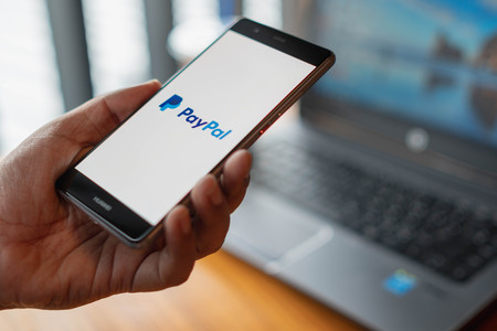 CHIANG MAI, THAILAND - July 13,2018: Man hands holding HUAWEI with PayPal apps on the screen. PayPal...