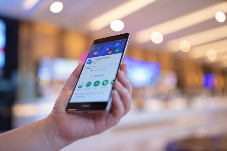 CHIANG MAI, THAILAND - August 03,2018: Woman hands holding HUAWEI with Google Translate on screen.Google Translate is a free multilingual machine translation service developed by Google to translate text.のeditorial素材