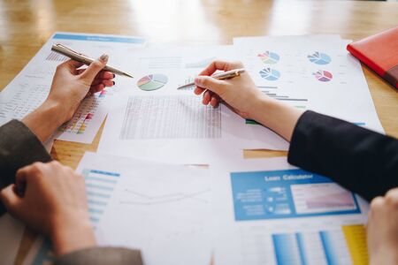 Businesswoman pointing pen on business document at meeting room.の写真素材