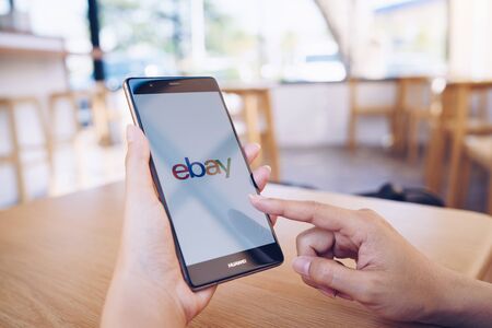 CHIANG MAI, THAILAND - JAN. 19,2019: Woman holding HUAWEI with eBay apps on the screen. eBay is one of the most popular ways to buy and sell goods and services on the internet.のeditorial素材