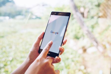 CHIANG MAI, THAILAND - JAN. 19,2019: Woman holding HUAWEI with google search on screen. Google is the biggest Internet search engine and online advertising technologies in the world.のeditorial素材