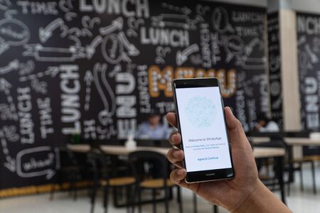 CHIANG MAI, THAILAND - JAN. 06,2019: Man holding OnePlus 6 with Whatsapp messenger on the screen.WhatsApp Messenger is a FREE messaging app to let you message and call friends and family.のeditorial素材