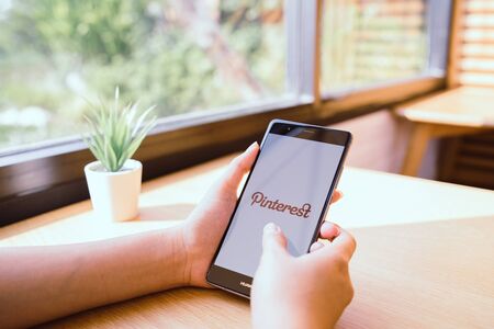 CHIANG MAI, THAILAND - JAN. 19,2019: Woman holding HUAWEI mobile phone with Pinterest apps on screen. Pinterest is an online pinboard that allows people to pin their interesting things.のeditorial素材