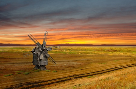 Sunset landscape with medieval windmill in steppe