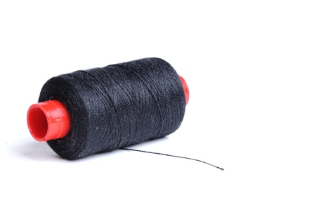 coil of black thread isolated on white