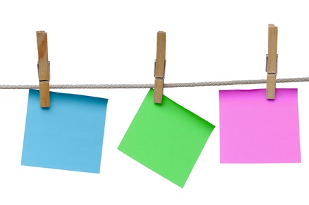 Note paper on clothespins isolated on a white background