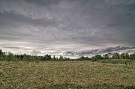 Dark dramatic landscape stormy sky over wetlandsの写真素材