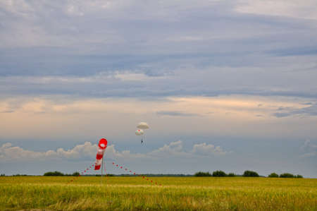 The parachutist descends on the main and reserve parachuteの写真素材