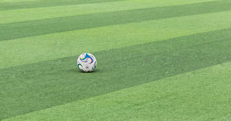 A football is waiting on the green football field, and a wonderful football match is about to kick off...の写真素材
