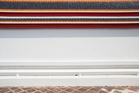 Flat plane of Thai's temple wall with colorful ceramic roof