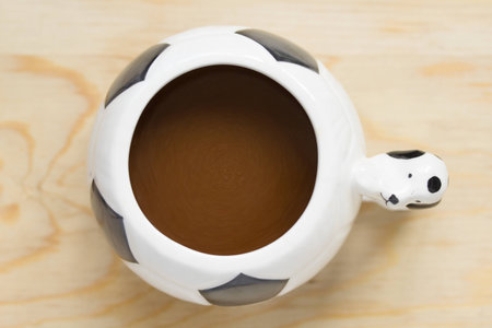 Coffee cup designed in football form.の写真素材