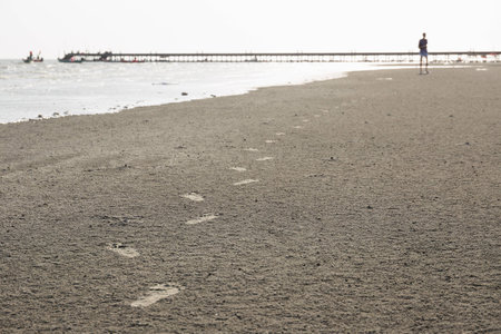 Footprint of running man on beachの写真素材