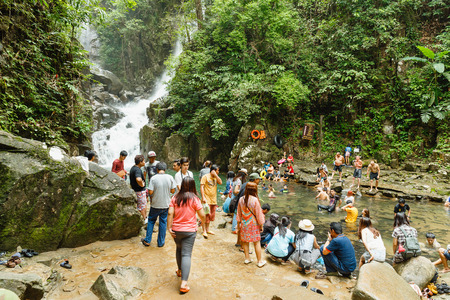 Phlio Waterfall, Thailand - July 4, 2015 : People are swimming in canal with fish at Phlio waterfall, Chanthaburi Province, Thailnad. Fish in this place like to eat cow-pea.のeditorial素材