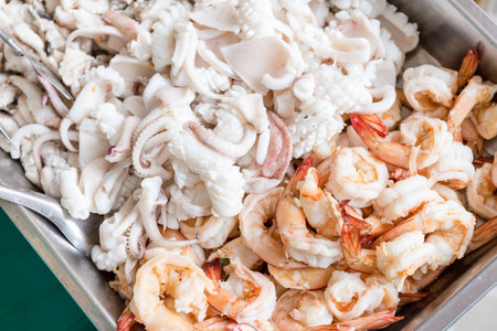 Pieces of fish, squid and shrimp are preparing for make rice congeeの写真素材