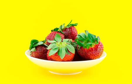 Strawberries on yellow backgroundの写真素材