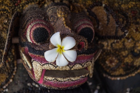 Traditional Balinese mask on a black background の写真素材