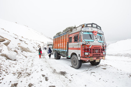 Ladakh, India - April, 17, 2014: Truck on the snow mountain and high altitude Khardung La Pass-Leh road, state of Ladakh, Indian Himalayas, Indiaのeditorial素材