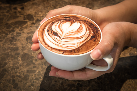 Barista serving a Latte coffeeの写真素材