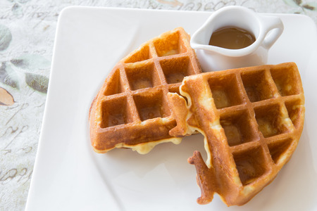 Tradition waffle with honey  in white plate on the tableの写真素材