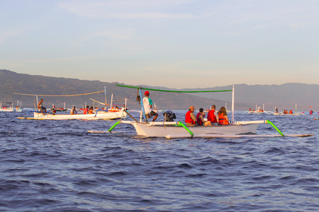 BALI, INDONESIA - May 29: Many tourists looking for dolphins at Lovina beach on May 29, 2014 in Bali, Indonesia. Popular activities for visitors include early-morning boat trips to see dolphins.のeditorial素材