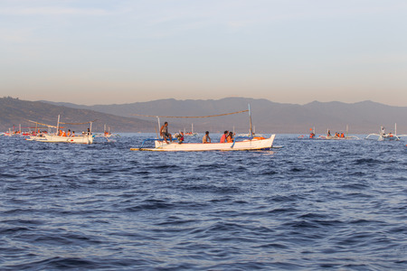 BALI, INDONESIA - May 29: Many tourists looking for dolphins at Lovina beach on May 29, 2014 in Bali, Indonesia. Popular activities for visitors include early-morning boat trips to see dolphins.のeditorial素材