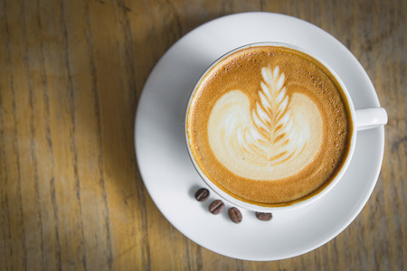Latte Art coffee  on wood tableの写真素材