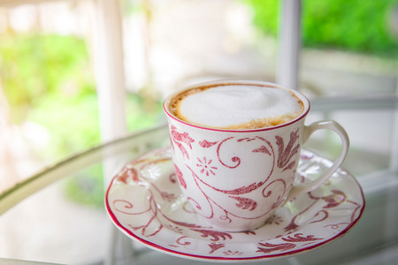 Cup of coffee on a window sillの写真素材
