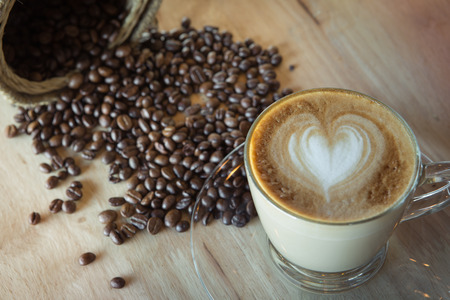 Coffee latte art with coffee bean in basketの写真素材