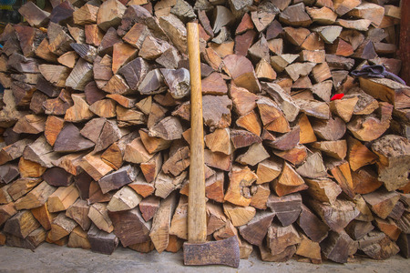 Old axe on a firewood background