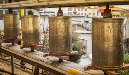 Buddhist prayer wheels in Tibetan monastery with written mantra.の写真素材