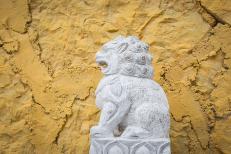 Lion statue with stone backgroundの写真素材