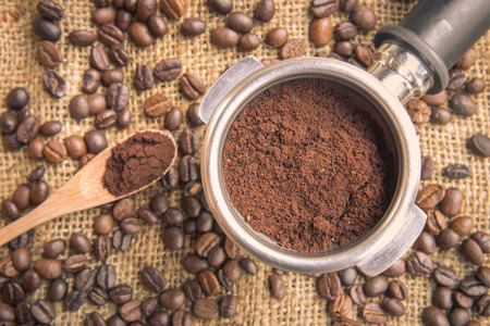 Fill coffee powder into port filter  with coffee bean の写真素材