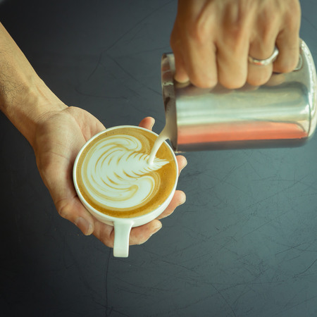 Pouring milk make latte art coffeeの写真素材